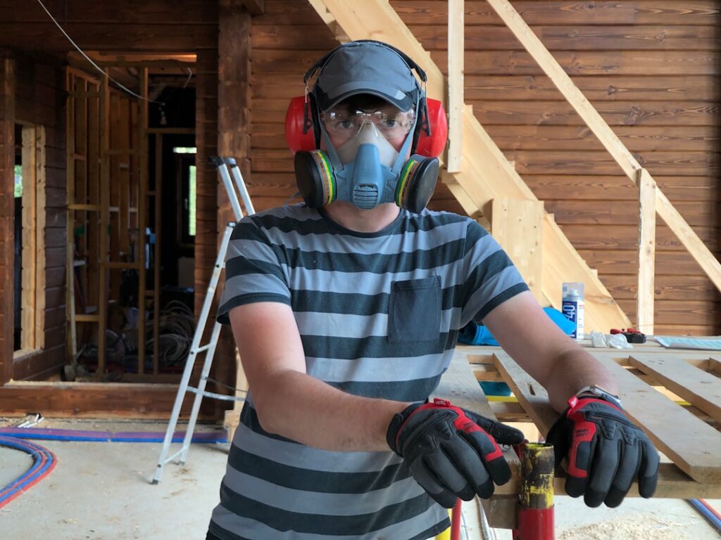 A certified contractor discusses radon mitigation options with a homeowner beside a basement sump system.